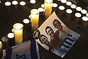 Candles placed next to a picture of three Israeli teenagers who were abducted and killed, in Tel Aviv's Rabin Square June 30, 2014. Israeli forces found the bodies of the three missing teenagers in the occupied West Bank on Monday after a nearly three-week-long search and a sweep against the Islamist Hamas group that Israel says abducted them. REUTERS/Nir Elias (ISRAEL - Tags: POLITICS CIVIL UNREST OBITUARY TPX IMAGES OF THE DAY)