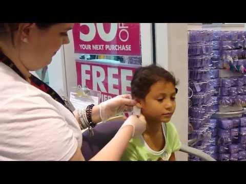 Julia getting her ears pierced at Claire's in the mall 05/26/2013