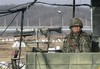 file - A South Korean army soldier stands guard at a military checkpoint near the border village of Panmunjom, which has separated the two Koreas since the Korean War, in Paju, South Korea, Wednesday, Jan. 1, 2014.