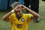 Brazil's Neymar forms a heart with his hands as he leaves the pitch after the World Cup round of 16 soccer match between Brazil and Chile at the Mineirao Stadium in Belo Horizonte, Brazil, Saturday, June 28, 2014. Brazil won 3-2 on penalties after the match ended 1-1 draw after extra-time.