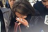 A distressed friend of Kazem Mohamadi Payam leaves court in tears.