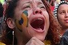 Devastated: Brazilian fans react on Rio's Copacabana beach.