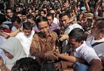 Indonesian presidential candidate Joko Widodo, popularly known as "Jokowi" center, is greeted by supporters after casting his ballot during the presidential election in Jakarta, Indonesia, Wednesday, July 9, 2014.