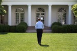 File - President Barack Obama walks through the Rose Garden of the White House, May 6, 2014.