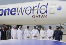 Qatar Airways Chief Executive Akbar Al Baker (3rd R), Qatar's Prime Minister Sheikh Abdullah bin Nasser bin Khalifa al-Thani (4th R), Qatar's Minister of Energy and Industry Mohammed Saleh al-Sada (2ndR) and other delegates pose in front of a Qatar Airways Boeing 777-300 aircraft during a ceremony to mark the alliance of Qatar Airways with the oneworld grouping at the Hamad International airport in Doha October 29, 2013. Qatar Airways joined oneworld on Tuesday, an alliance which includes British Airways, as the Gulf carrier looks to expand its global reach through partnerships. REUTERS/Fadi Al-Assaad