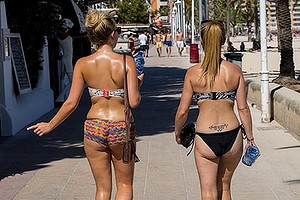 Tourist walks on the promenade at Magaluf beach on July 12, 2014 in Mallorca, Spain.