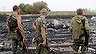 Armed pro-Russian separatists stand at the site of a Malaysia Airlines Boeing 777 plane crash near the settlement of Grabovo in the Donetsk region, July 17, 2014. The Malaysian airliner Flight MH-17 was brought down over eastern Ukraine on Thursday, killing all 295 people aboard and sharply raising the stakes in a conflict between Kiev and pro-Moscow rebels in which Russia and the West back opposing sides. REUTERS/Maxim Zmeyev (UKRAINE - Tags: TRANSPORT DISASTER POLITICS CIVIL UNREST)