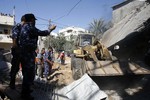 Palestinians inspect a house which police said was destroyed in an Israeli air strike in Khan Younis in southern Gaza Strip on July 8, 2014. Israeli aircraft carried out a massacre of the family of Khan Younis Kaware resulted in the deaths of seven people and wounding 25 others seriously injured, including women and children. Photo by Ahmad Deeb / WN