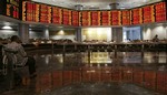 Investors look at the share index at a private stock market gallery in Kuala Lumpur, Malaysia, Friday, Oct. 10, 2008.