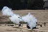 An Israeli mobile artillery unit fires towards Gaza.