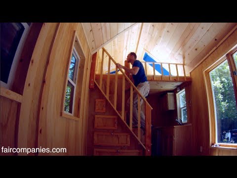 Tiny home packs storage stairs, 2 lofts, tub in 136 sq ft