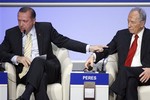 Recep Tayyip Erdogan, Prime Minister of Turkey, left, talks to Shimon Peres, President of Israel, right, during a plenary session during the Annual Meeting of the World Economic Forum, WEF, in Davos, Switzerland, Thursday, Jan. 29, 2009.