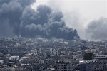 Smoke rises after an Israeli missile hit Shijaiyah neighborhood in Gaza City, northern Gaza Strip, Sunday, July 20, 2014.