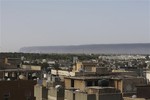 Smoke rises on the horizon in Tripoli, Libya, early Sunday, July 13, 2014.