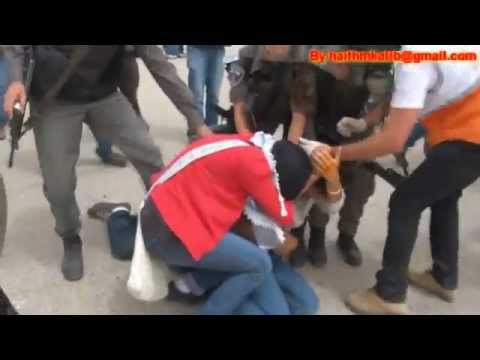 Israeli soldiers beating a Palestinian girl and remove her Hijab