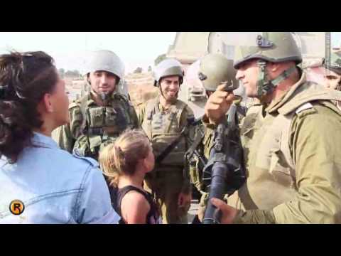 Palestinian girl in front of Israeli soldiers.