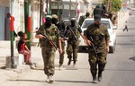 A Palestinian militants of the Ezzedine al-Qassam Brigades, Hamas's armed wing, parade in Rafah, southern Gaza Strip, on May 29, 2014. Palestinian president Mahmud Abbas sent a "letter of designation" to Rami Hamdallah, who is currently serving as premier within the West Bank-based government, to head a unity government but announcement of the lineup was held up over the foreign affairs portfolio. Hamas and the Western-backed PLO, which is dominated by Abbas's secular Fatah party, signed a surprise reconciliation agreement on April 23 to end years of bitter and sometime bloody rivalry. Photo by Ahmed Deeb / WN