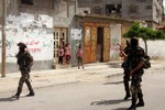 A Palestinian militants of the Ezzedine al-Qassam Brigades, Hamas's armed wing, parade in Rafah, southern Gaza Strip, on May 29, 2014. Palestinian president Mahmud Abbas sent a "letter of designation" to Rami Hamdallah, who is currently serving as premier within the West Bank-based government, to head a unity government but announcement of the lineup was held up over the foreign affairs portfolio. Hamas and the Western-backed PLO, which is dominated by Abbas's secular Fatah party, signed a surprise reconciliation agreement on April 23 to end years of bitter and sometime bloody rivalry. Photo by Ahmed Deeb / WN