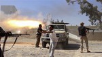 In this Saturday, July 26, 2014 frame grab from video obtained from a freelance journalist traveling with the Misarata brigade, fighters from the Islamist Misarata brigade fire towards Tripoli airport in an attempt to wrest control from a powerful rival militia, in Tripoli, Libya