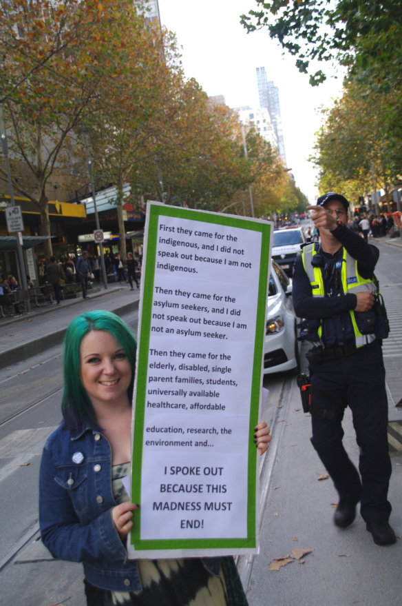 Young woman with placard of variant of classic "First they came for ..." 