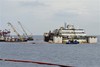 The luxury cruise ship Costa Concordia is seen as it moves away from the underwater platform where it laid during operations to put it afloat, on the tiny Tuscan island of Giglio, Italy, Monday, July 14, 2014.