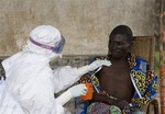 File - A 43 year old Congolese patient, right, who has been confirmed to have Ebola hemorrhagic fever, following laboratory tests, is comforted by Medecins Sans Frontieres (Doctors without Borders) nurse Isabel Grovas, left, and Doctor Hilde Declerck, not pictured, in Kampungu, Kasai Occidental province, Congo, Saturday, Sept. 29, 2007.