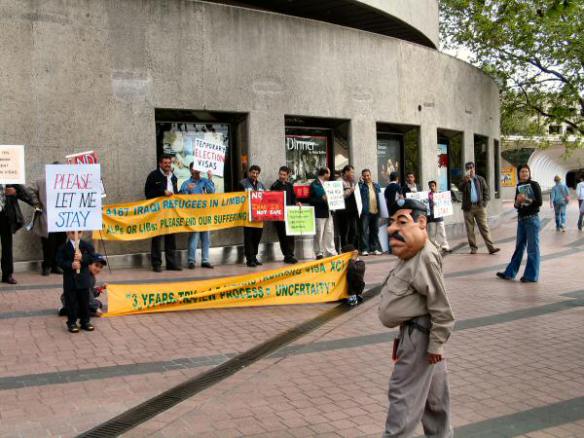 Refugees with banners - End our suffering ...