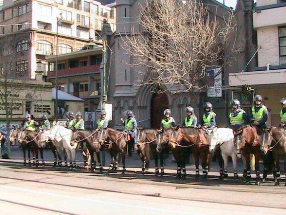 Mounted police lined up across street