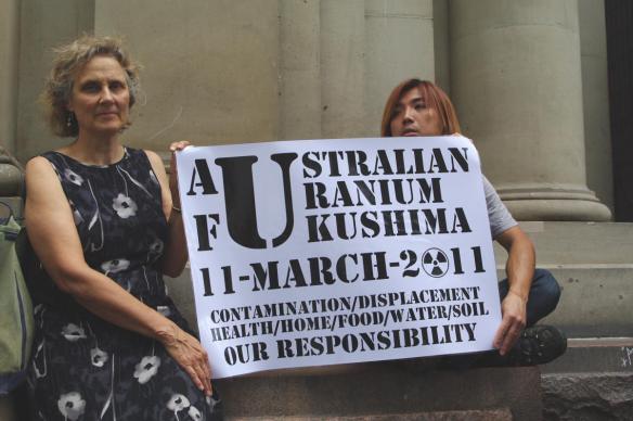 Placard linkg Fukushima and Australian uranium