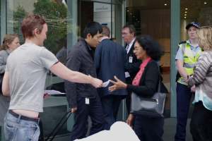 Handing a leaflet to a passer-by