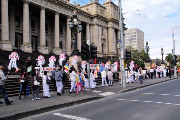 Another part of the procession passes the rally