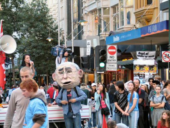 Protester wearing head of John Howard