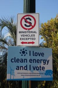 Greenpeace placard on pole beneath No standing sign - Ministerial Vehicles Excepted