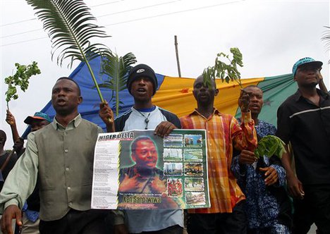 Protesters march to remember the 10th anniversary of a military junta's execution of Ken Saro-Wiwa at the city of Port Harcourt, Nigeria, on Thursday, Nov. 10, 2005.