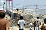  Palestinian children follow an Israeli tank as it rolls through the Gaza town of Beit Hanoun. Tanks, troops and bulldozers reoccupied a Gaza town yesterday in a bid to curb Hamas rocket attacks on Israel, after the crudely made missiles claimed their fir