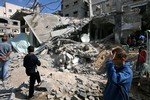  Palestinians inspect the rubble of a house belonging to a member of Hamas military wing which was destroyed in an Israeli attack on the Gaza Strip.