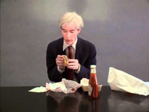 Andy Warhol eating a hamburger