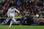 Real Madrid's Cristiano Ronaldo from Portugal scores a goal against Atletico de Madrid during a Spanish La Liga soccer match at the Vicente Calderon stadium, in Madrid, Wednesday, April 11, 2012.