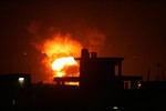 Fire rises during an explosion following an Israeli strike on the border tunnels between Egypt and Rafah in the southern Gaza Strip on November 20, 2012. In a backdrop of airstrikes and mounting casualties, American efforts to negotiate a cease-fire in the latest Gaza fighting between Israel and Hamas continues. Photo by Ahmed Deeb / WN