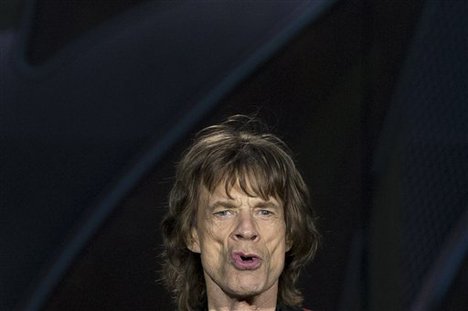 Singer Mick Jagger of British band, the Rolling Stones, reacts as they perform, at Real Madrid's Santiago Bernabeu soccer stadium, in Madrid