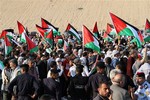 Pro-Palestinian demonstrators hold Palestinian flags as they attempt to reach the Israeli border but were blocked by Jordanian police, in Southern Souneh, Jordan Sunday, May 15, 2011.