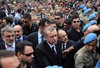 In this photo released by the Turkish Prime Minister's Press Office, Turkish Prime Minister Recep Tayyip Erdogan is surrounded by security members as he visits the coal mine in Soma, Turkey, Wednesday, May 14, 2014.