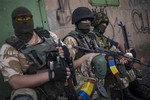 Ukrainian government soldiers from battalion "Donbass" rest at their positions in village Mariinka near Donetsk, eastern Ukraine, Monday, Aug. 11, 2014.