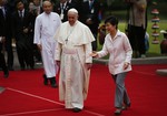 South Korean President Park Geun-hye, right, leads Pope Francis, center, after a welcoming ceremony at the presidential Blue House in Seoul, South Korea, Thursday, Aug. 14, 2014. Pope Francis became the first pontiff in 25 years to visit South Korea on Thursday, bringing a message of peace and reconciliation to the war-divided peninsula.