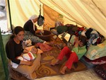 Displaced Iraqis from the Yazidi community settle in a tent at Nowruz camp, in Derike, Syria, Tuesday, Aug. 12, 2014.