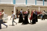 Palestinian families leave their neighborhood to a safer location as Israel's army continues shelling the area of Khan Yunis, in the southern Gaza Strip.