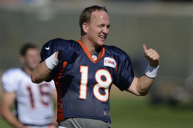 Broncos quarterback Peyton Manning, above, stretches Tuesday before practice. Teammate Rahim Moore said of Manning: &quot;He&#8217;s training like