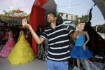 A Palestinian man inspects the damage to his shop which sells women's clothing, in Rafah town, in the southern Gaza Strip,