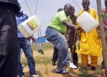 People wash their hands with disinfectant as a preventative measure against the Ebola virus, in the city of Monrovia, Liberia. Thursday, Aug. 14, 2014.