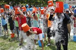 Boston City Councillor Tito Jackson, right, leads some 200 people in the ice bucket challenge at Boston's Copley Square